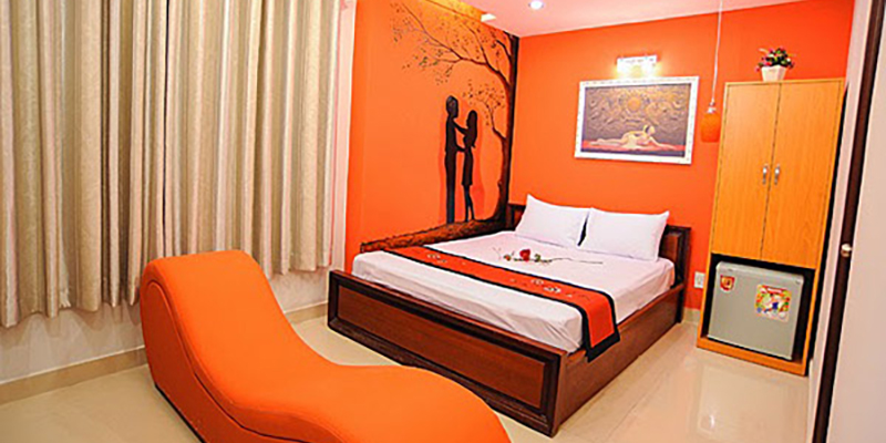 A bedroom with orange wallsDescription automatically generated with medium confidence